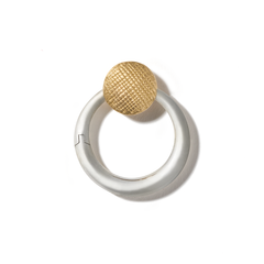 Silver circle charm with yellow gold clasp against white backdrop
