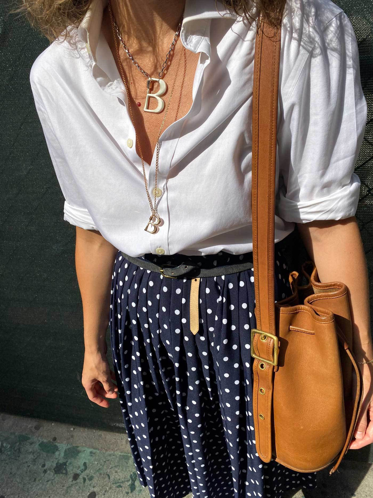 Woman wearing necklace with B lock