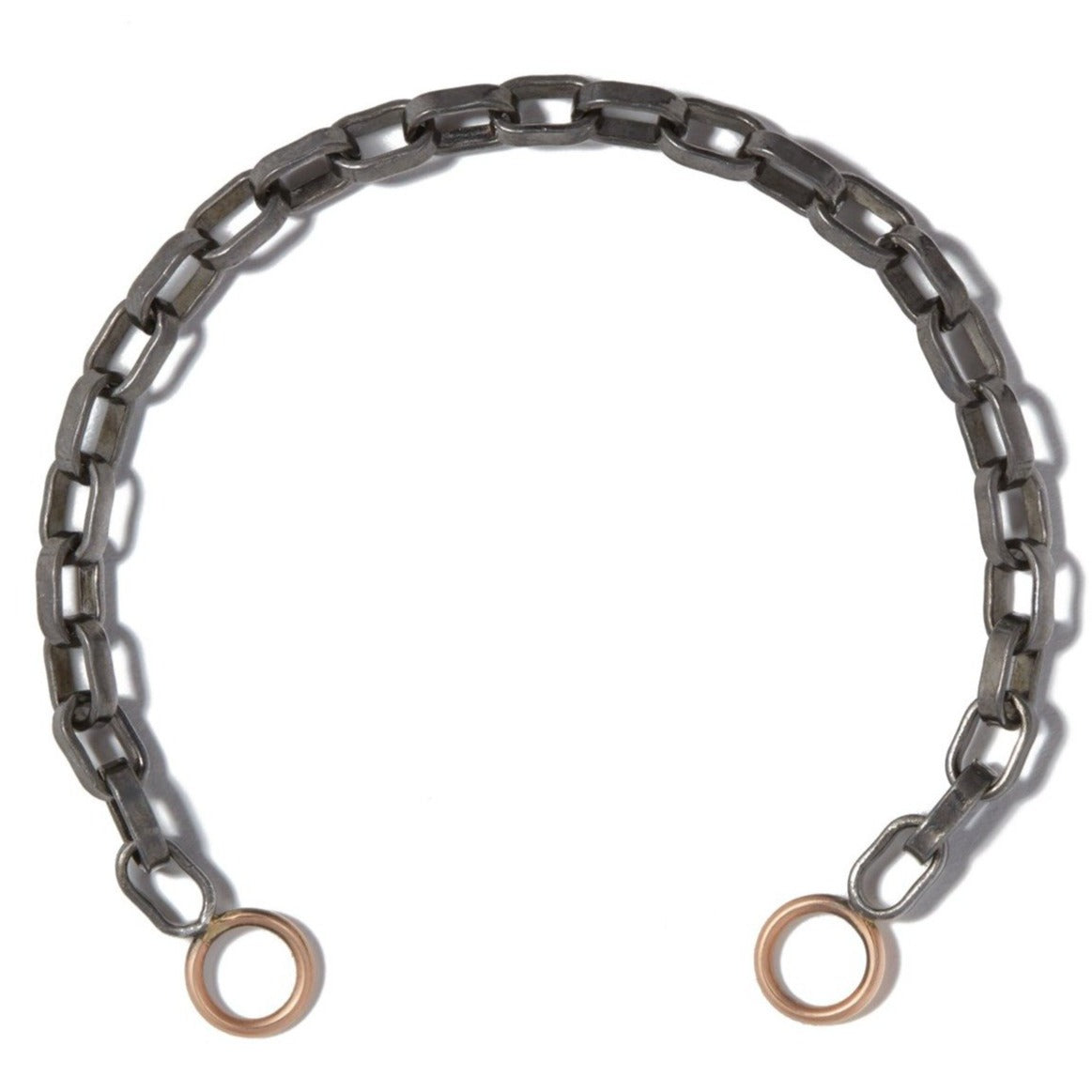 Close up of blackened silver chain bracelet with rose gold loops