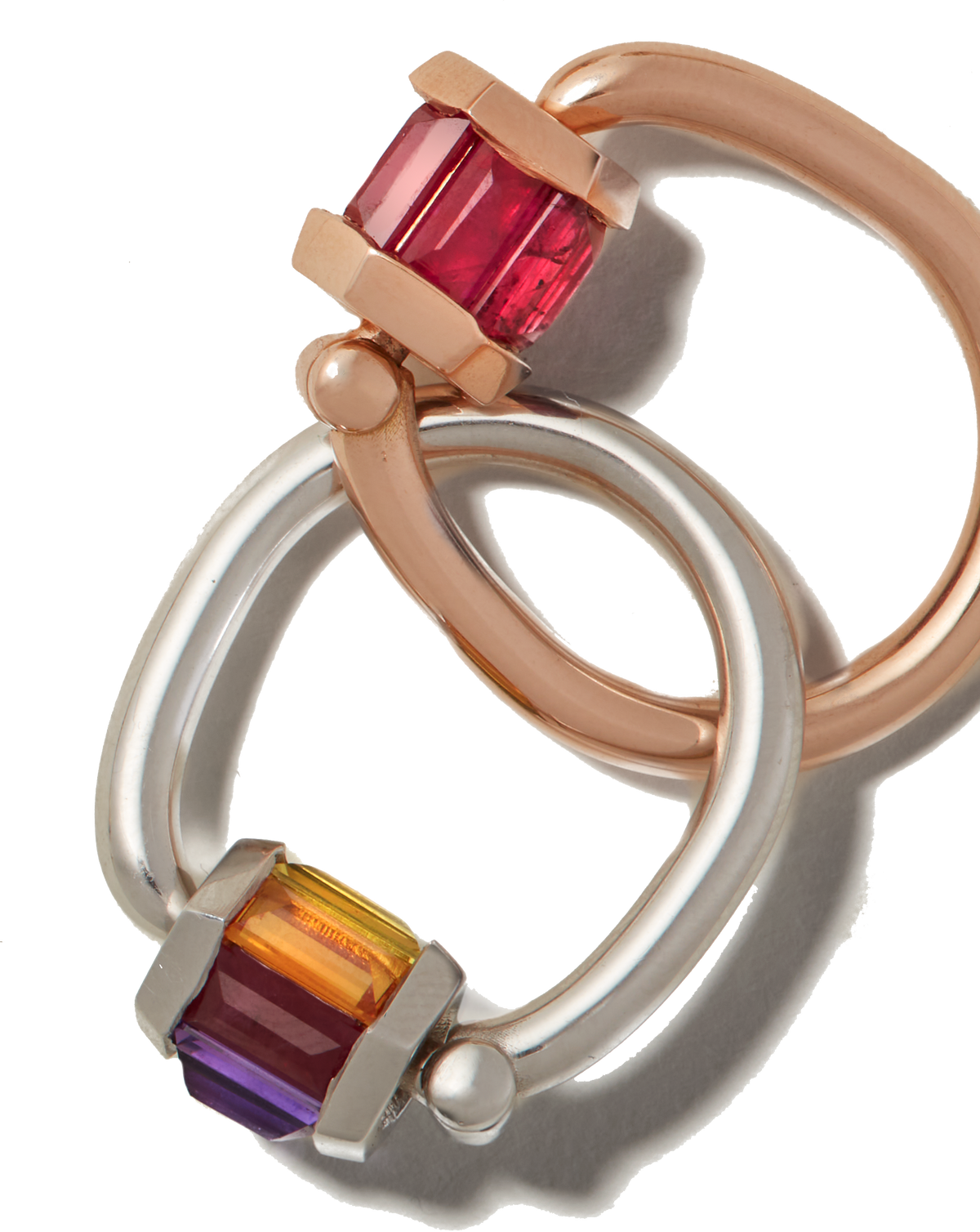 Rose gold ruby ring interlocked with silver rainbow gemstone ring
