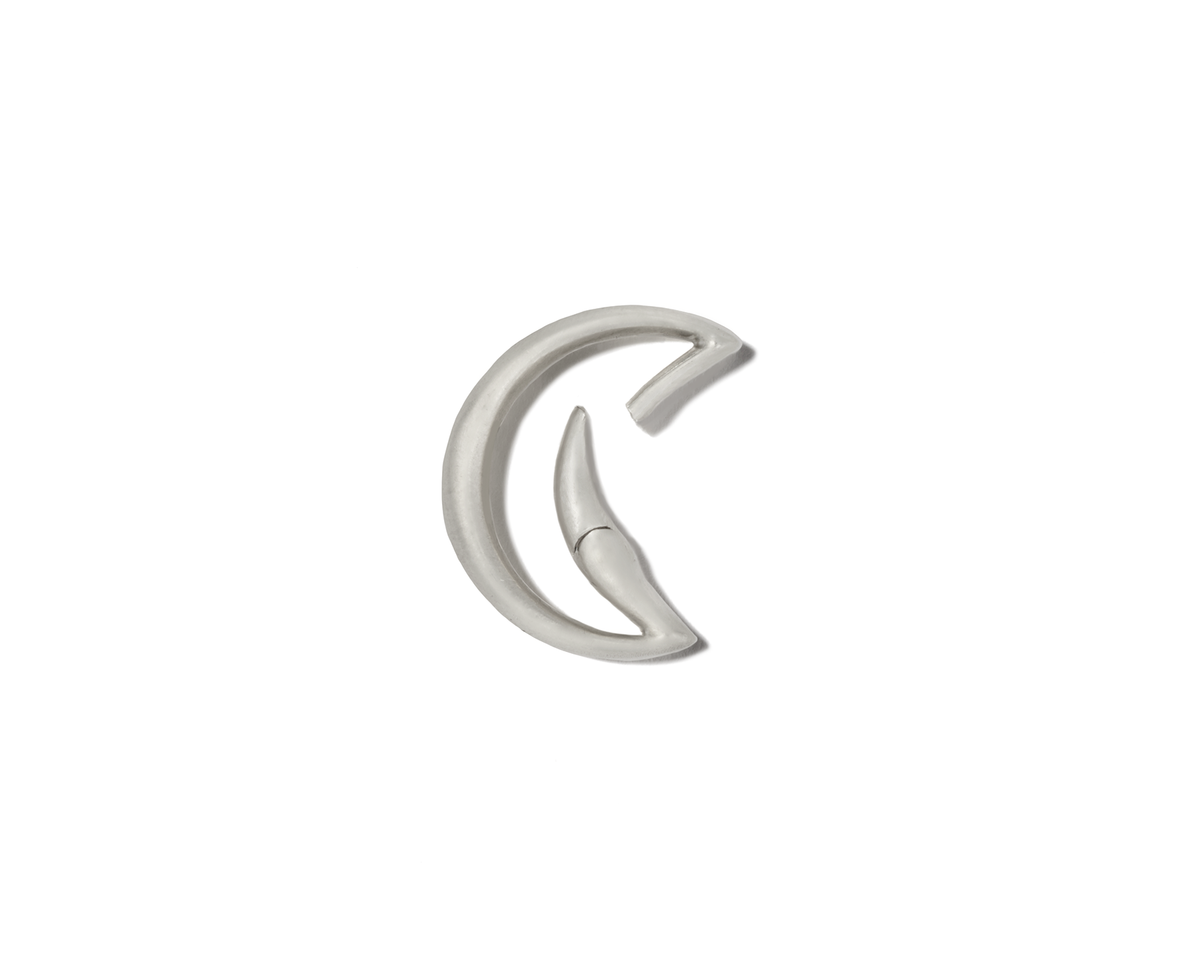 Silver moon charm with open clasp against white backdrop