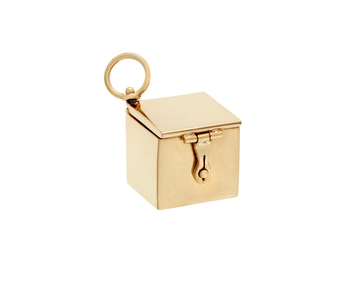 Gold box charm against white backdrop