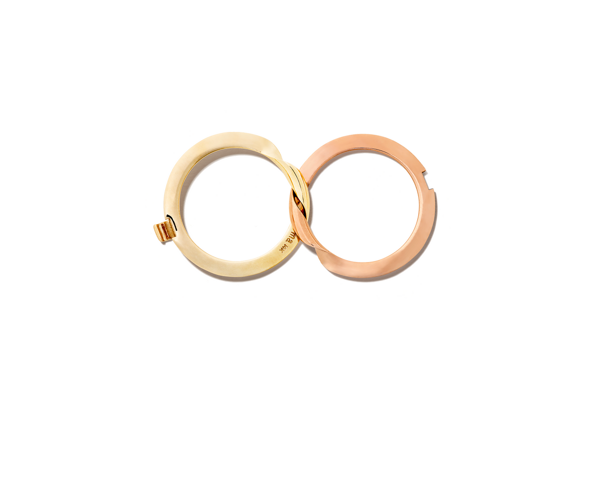 Aerial view of rose gold and yellow gold intertwined rings